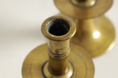 Lot 542 - A RARE PAIR OF 17TH/18TH CENTURY ENGLISH BRASS TRUMPET CANDLE STICKS