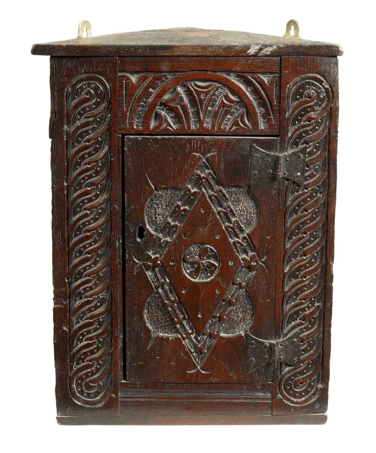 Lot 1025 - A 17TH-CENTURY SMALL CARVED OAK HANGING CORNER CUPBOARD