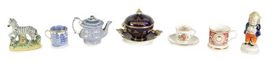Lot 53 - AN EARLY 19TH CENTURY STAFFORDSHIRE MODEL OF A ZEBRA, A STAFFORDSHIRE FIGURAL PEPPERETTE, A BLUE AND WHITE CUP, A TEAPOT WITH AN ORIENTAL LID, A ROYAL BLUE AND GILT PLATED BOWL ON STAND