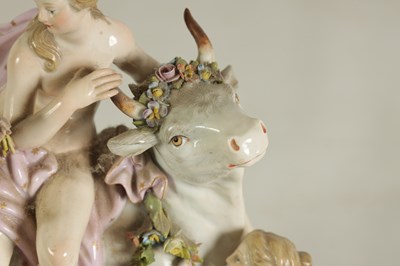 Lot 49 - A 19TH CENTURY MEISSEN FIGURE GROUP OF A BULL WITH A SEATED LADY RIDER AND A FLOWER SELLER