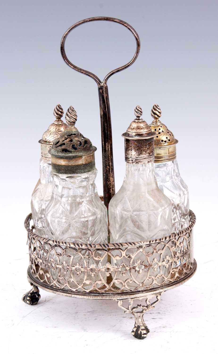 Lot 331 - A GEORGE III FIVE BOTTLE SILVER CRUET STAND...