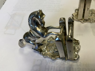 Lot 470 - A SET OF FOUR SILVER HORSE MENU HOLDERS