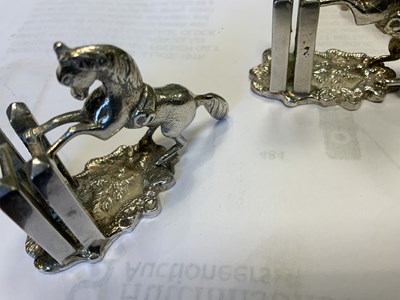 Lot 470 - A SET OF FOUR SILVER HORSE MENU HOLDERS