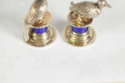 Lot 324 - A CASED SET OF FOUR SILVER AND GUILLOCHE ENAMEL GAME BIRD MENU HOLDERS