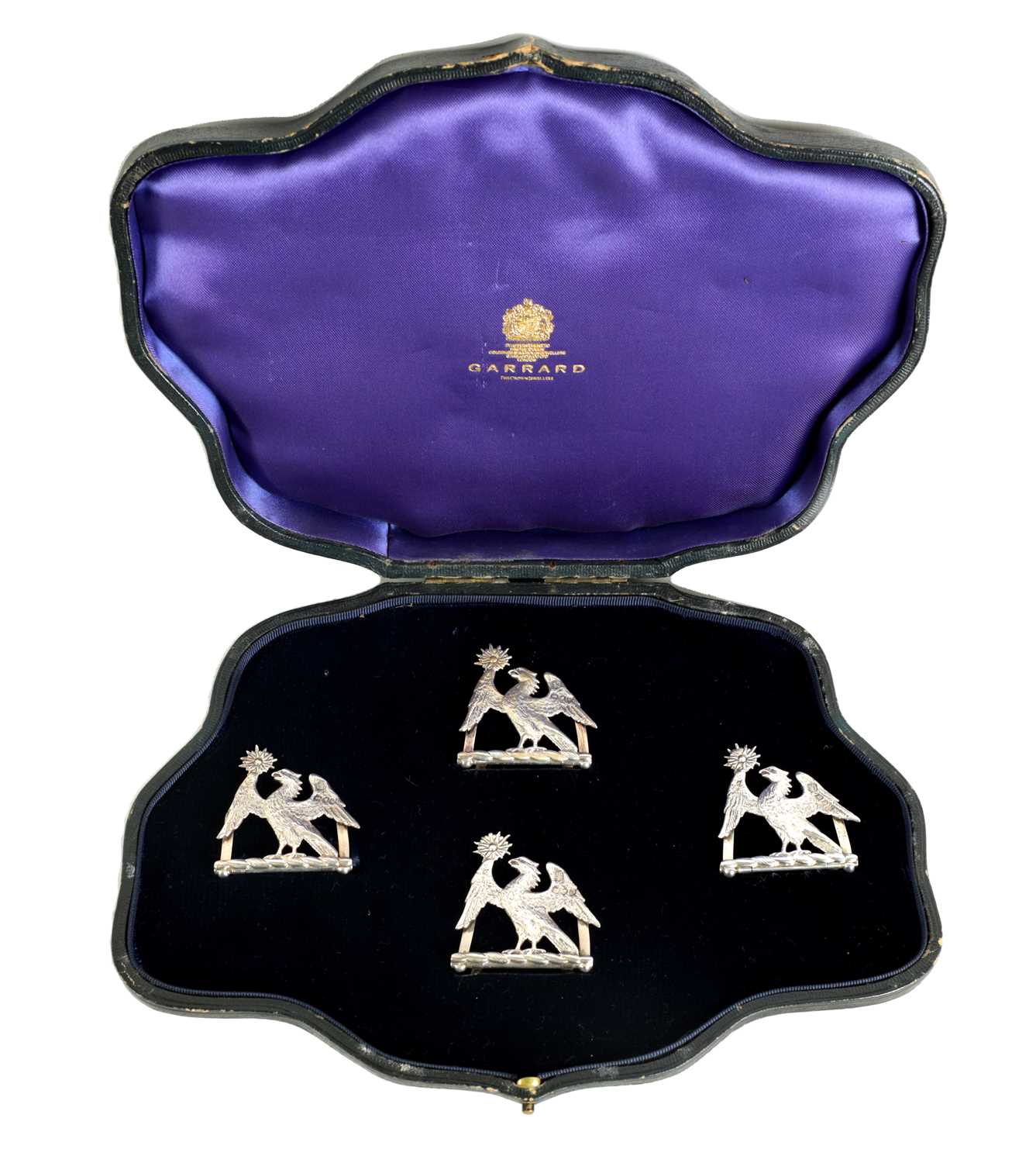 Lot 345 - A CASED SET OF FOUR LATE 19TH CENTURY SILVER HERALDIC MENU HOLDERS