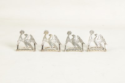 Lot 345 - A CASED SET OF FOUR LATE 19TH CENTURY SILVER HERALDIC MENU HOLDERS