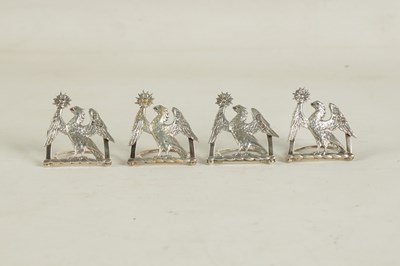 Lot 345 - A CASED SET OF FOUR LATE 19TH CENTURY SILVER HERALDIC MENU HOLDERS