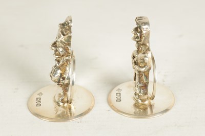 Lot 352 - A SET OF THREE CAST SILVER FIGURAL MENU HOLDERS OF PUNCH AND JUDY AND DOG