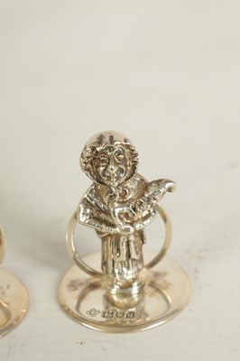 Lot 352 - A SET OF THREE CAST SILVER FIGURAL MENU HOLDERS OF PUNCH AND JUDY AND DOG