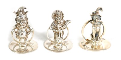 Lot 352 - A SET OF THREE CAST SILVER FIGURAL MENU HOLDERS OF PUNCH AND JUDY AND DOG