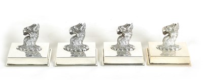 Lot 410 - A SET OF FOUR LATE VICTORIAN CAST SILVER GRIFFIN HEAD MENU HOLDERS