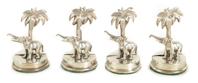 Lot 327 - A CASED SET OF FOUR SILVER ELEPHANT AND PALM TREE MENU HOLDERS