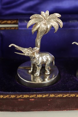 Lot 327 - A CASED SET OF FOUR SILVER ELEPHANT AND PALM TREE MENU HOLDERS