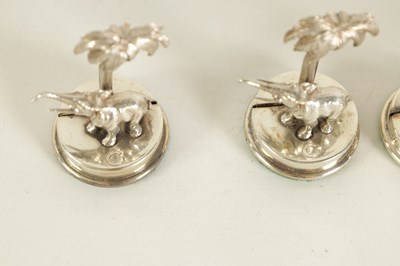 Lot 327 - A CASED SET OF FOUR SILVER ELEPHANT AND PALM TREE MENU HOLDERS