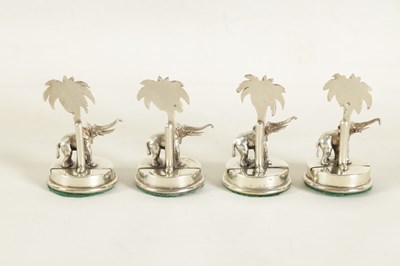 Lot 327 - A CASED SET OF FOUR SILVER ELEPHANT AND PALM TREE MENU HOLDERS