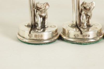 Lot 327 - A CASED SET OF FOUR SILVER ELEPHANT AND PALM TREE MENU HOLDERS