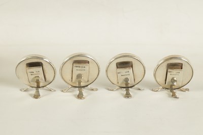 Lot 433 - A CASED SET OF FOUR CIRCULAR SILVER AND PAINTED DOG'S HEAD MENU HOLDERS