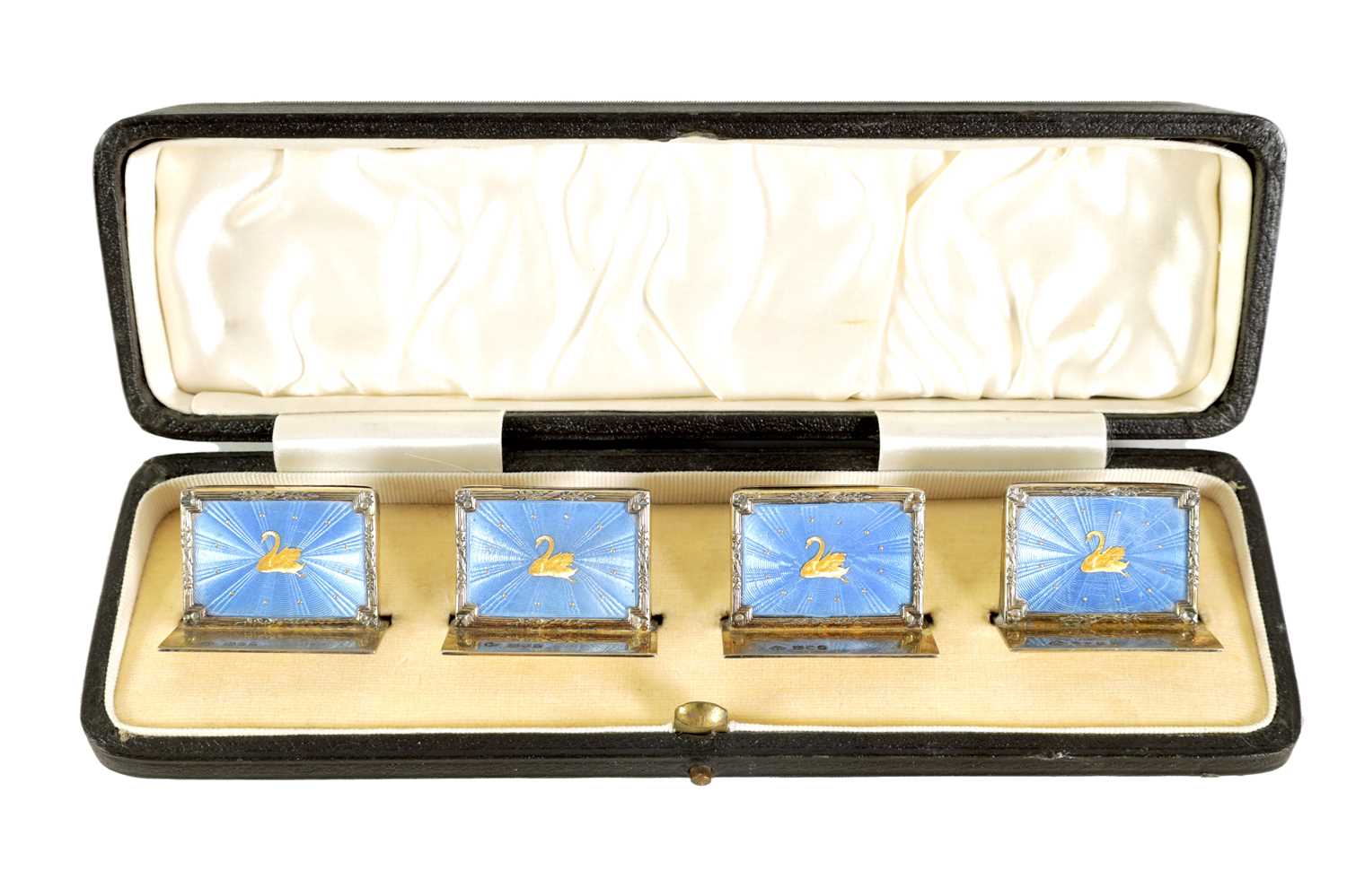 Lot 479 - A CASED SET OF FOUR SILVER GILT AND BLUE GUILLOCHE ENAMEL MENU HOLDERS