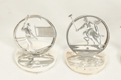 Lot 332 - A CASED SET OF FOUR SILVER SPORTING SCENE MENU HOLDERS