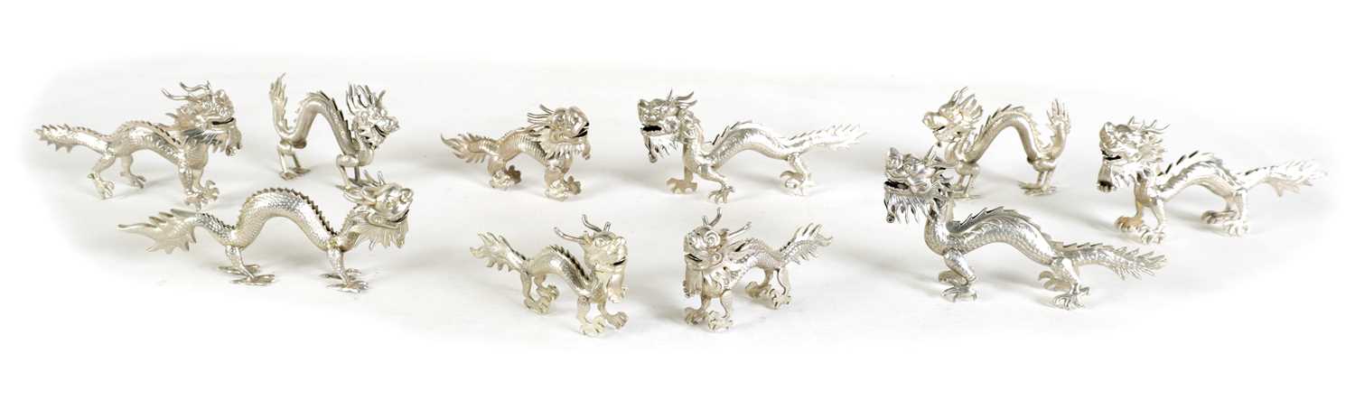 Lot 147 - A SET OF TEN LATE 19TH CENTURY CHINESE SILVER DRAGON MENU HOLDERS