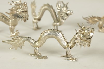 Lot 147 - A SET OF TEN LATE 19TH CENTURY CHINESE SILVER DRAGON MENU HOLDERS