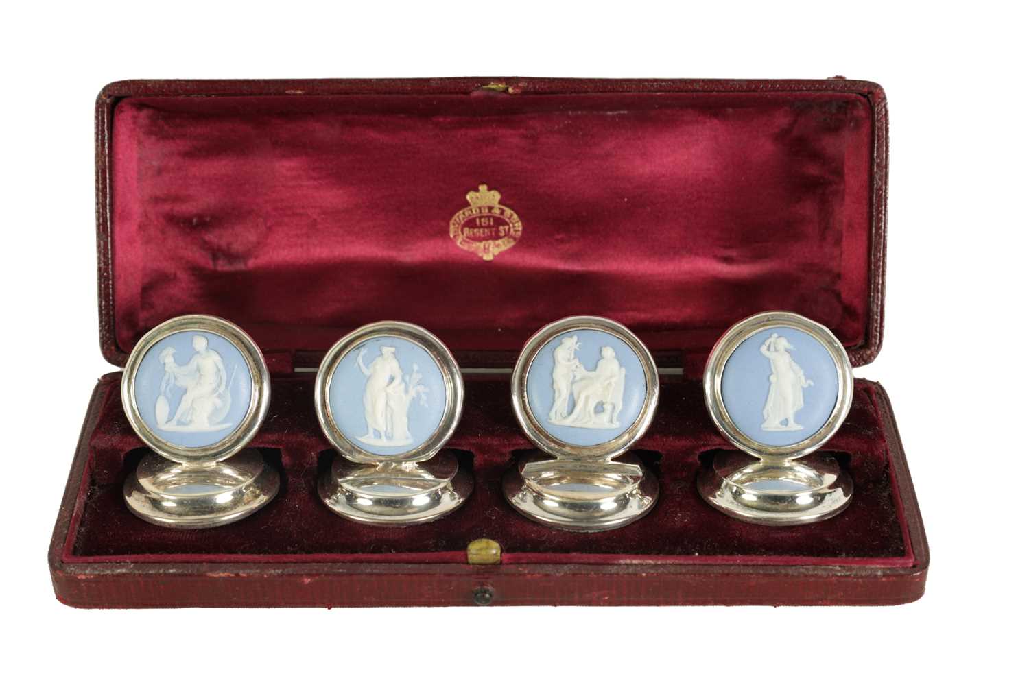 Lot 450 - A CASED SET OF FOUR WEDGWOOD SILVER MENU HOLDERS