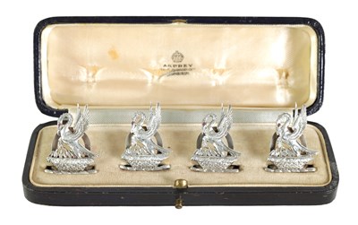 Lot 395 - A CASED SET OF FOUR SILVER HERALDIC MENU HOLDERS BY ASPREY