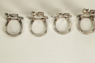 Lot 395 - A CASED SET OF FOUR SILVER HERALDIC MENU HOLDERS BY ASPREY