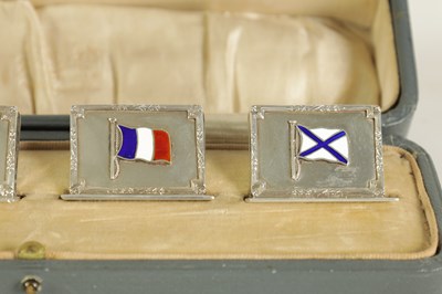 Lot 340 - A CASED SET OF FOUR SILVER AND ENAMEL FLAG MENU HOLDERS