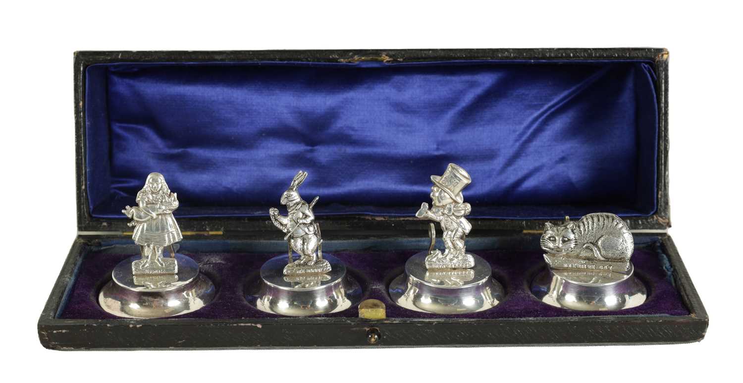 Lot 351 - A CASED SET OF FOUR SILVER 'ALICE IN WONDERLAND' MENU HOLDERS