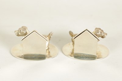 Lot 350 - A CASED PAIR OF CAST SILVER NORFOLK TERRIER MENU HOLDERS