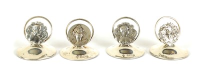 Lot 440 - A SET OF FOUR ART NOVEAU SILVER MENU HOLDERS