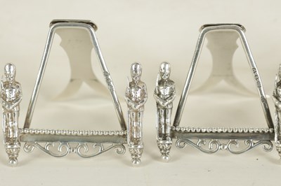 Lot 438 - A SET OF SEVEN SILVER FIGURAL MENU HOLDERS