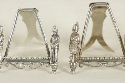 Lot 438 - A SET OF SEVEN SILVER FIGURAL MENU HOLDERS