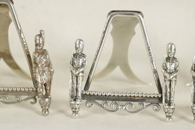 Lot 438 - A SET OF SEVEN SILVER FIGURAL MENU HOLDERS