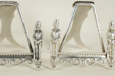 Lot 438 - A SET OF SEVEN SILVER FIGURAL MENU HOLDERS