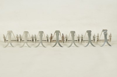 Lot 438 - A SET OF SEVEN SILVER FIGURAL MENU HOLDERS