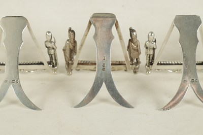 Lot 438 - A SET OF SEVEN SILVER FIGURAL MENU HOLDERS