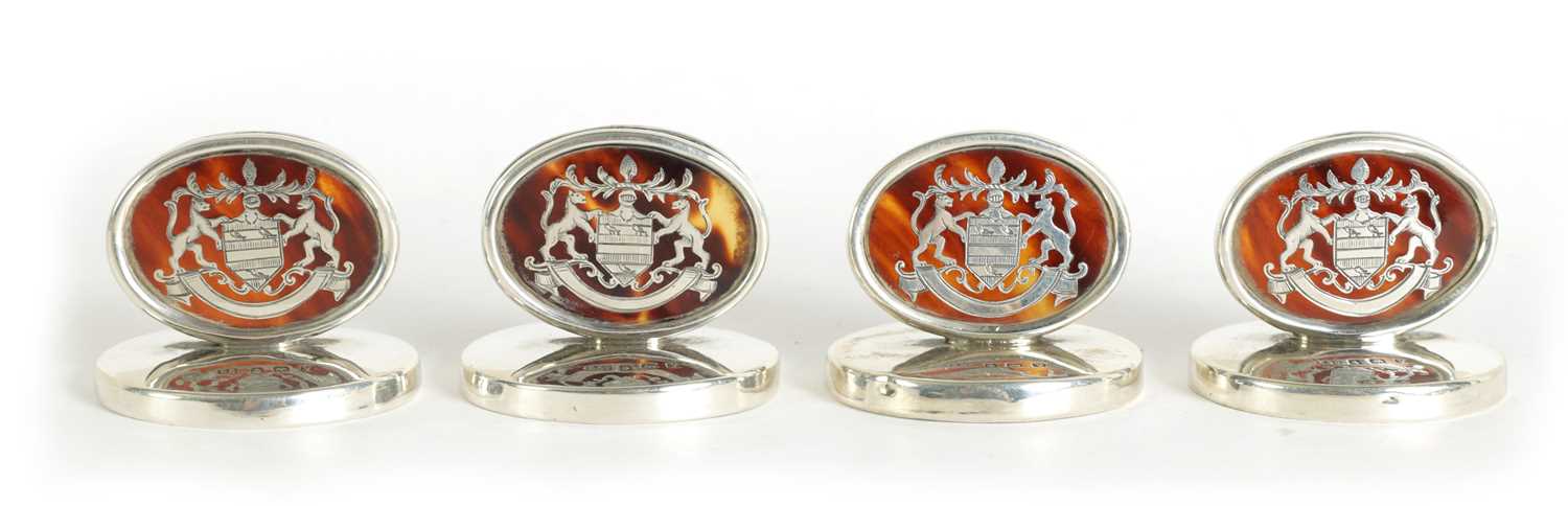 Lot 328 - A SET OF FOUR SILVER AND TORTOISESHELL ARMORIAL MENU HOLDERS