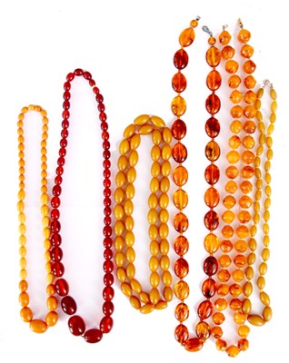 Lot 377 - A SELECTION OF SIX AMBER COLOURED NECKLACES of...