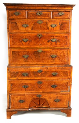 Lot 1049 - A SMALL 18TH CENTURY FIGURED WALNUT CHEST ON CHEST WITH STARBURST CENTRE