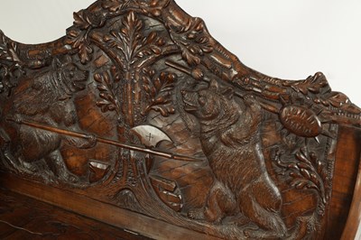 Lot 1037 - AN EARLY 20TH CENTURY CARVED LINDEN WOOD BLACK FOREST HALL BENCH