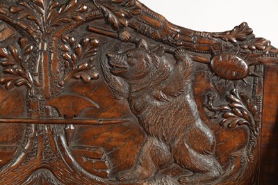 Lot 1037 - AN EARLY 20TH CENTURY CARVED LINDEN WOOD BLACK FOREST HALL BENCH