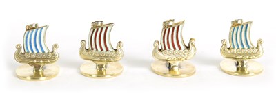 Lot 389 - A SET OF FOUR NORWEGIAN SILVER GILT AND ENAMEL VIKING SHIP MENU HOLDERS