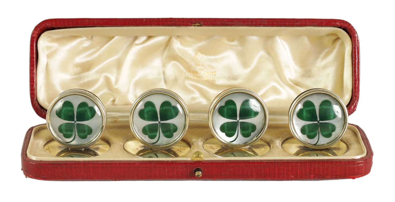 Lot 344 - A CASED SET OF FOUR SILVER AND MOTHER OF PEARL SHAMROCK MENU HOLDERS