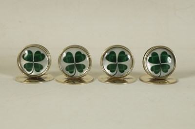 Lot 344 - A CASED SET OF FOUR SILVER AND MOTHER OF PEARL SHAMROCK MENU HOLDERS