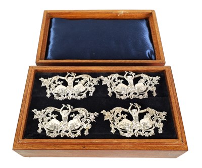 Lot 381 - A BOXED SET OF FOUR LATE 19TH CENTURY MONKEY AND DRUM SILVER MENU HOLDERS