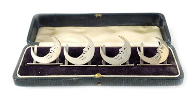 Lot 446 - A CASED SET OF FOUR 'MAN IN THE MOON' SILVER MENU HOLDERS