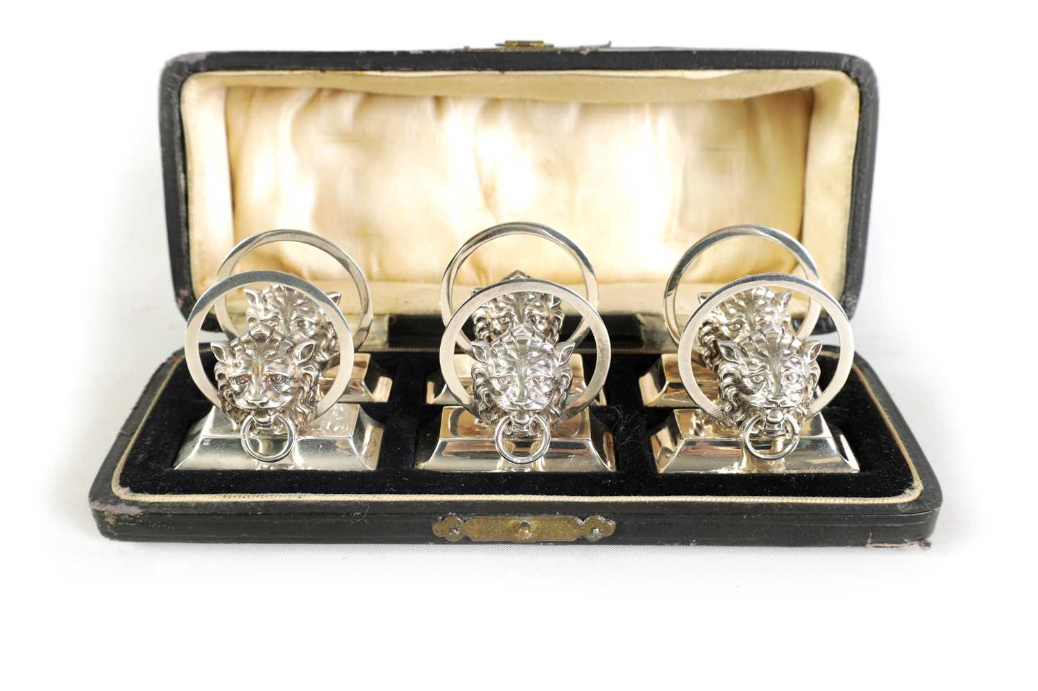 Lot 458 - A CASED SET OF SIX LION MASK DOOR KNOCKER SILVER MENU HOLDERS