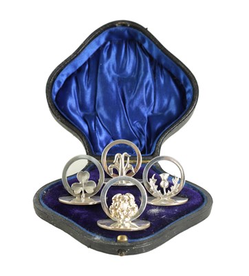 Lot 322 - A CASED SET OF FOUR SILVER SYMBOLIC MENU HOLDERS